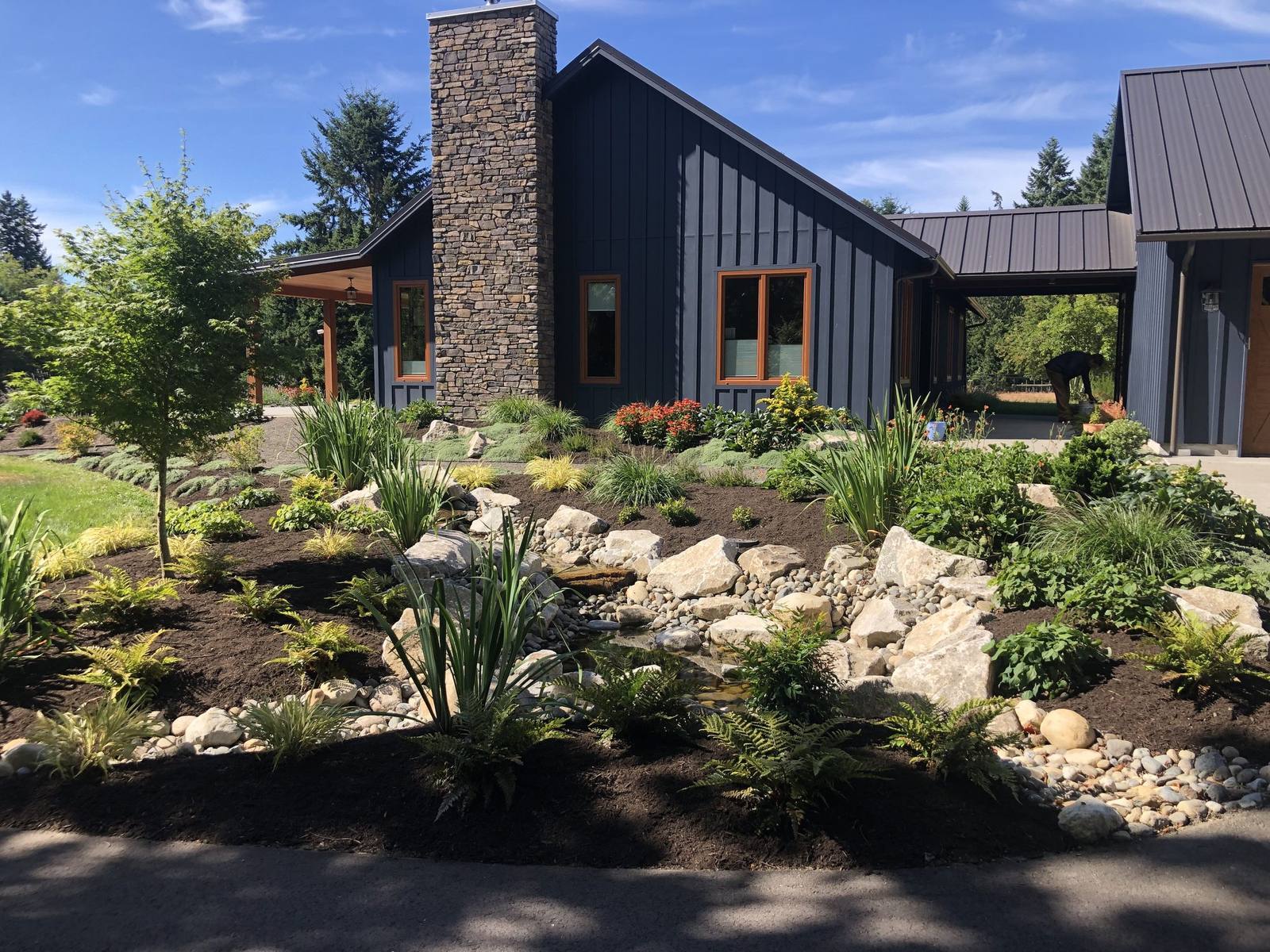 Finished stream garden across the front of the modern country home