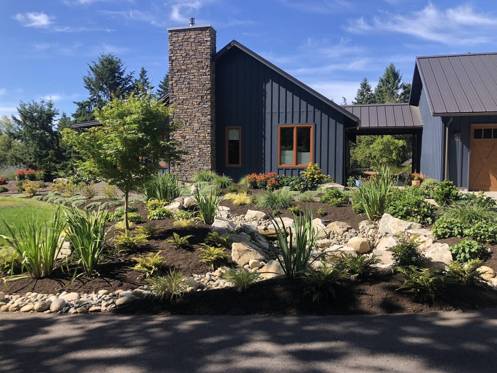 Sunny view of the modern country home and stream landscape